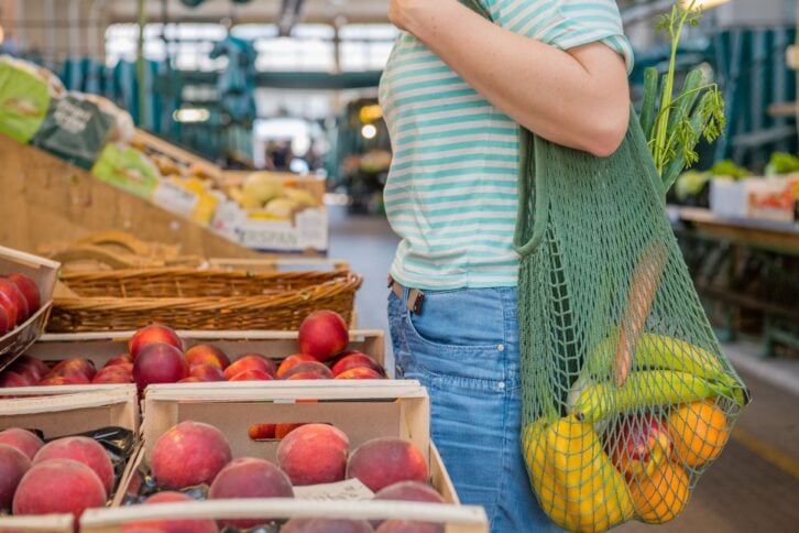 fruits and vegetables in a cotton mesh reusable bag