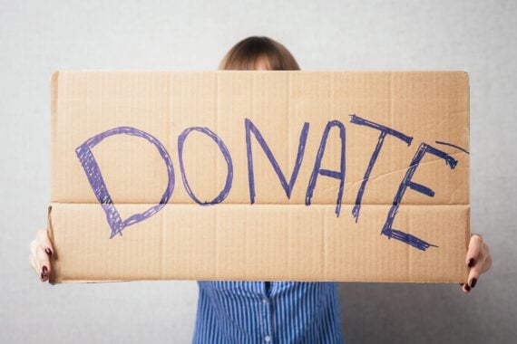 woman holding donation sign