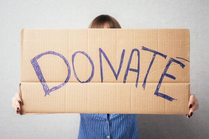 woman holding donation sign