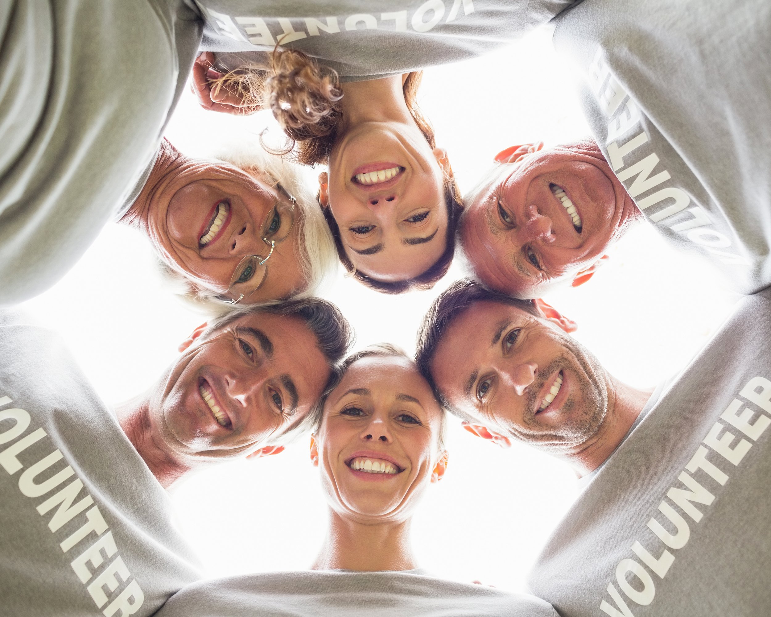 happy volunteer family looking down at the camera on a sunny day