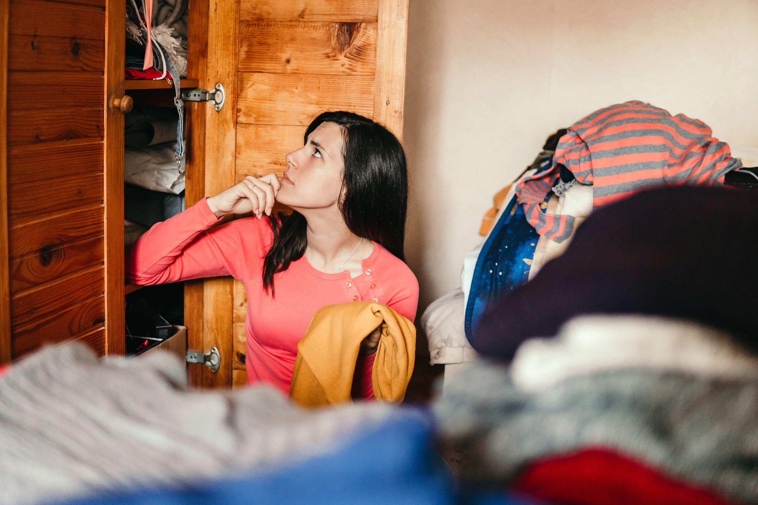 young woman is sorting out wardrobe