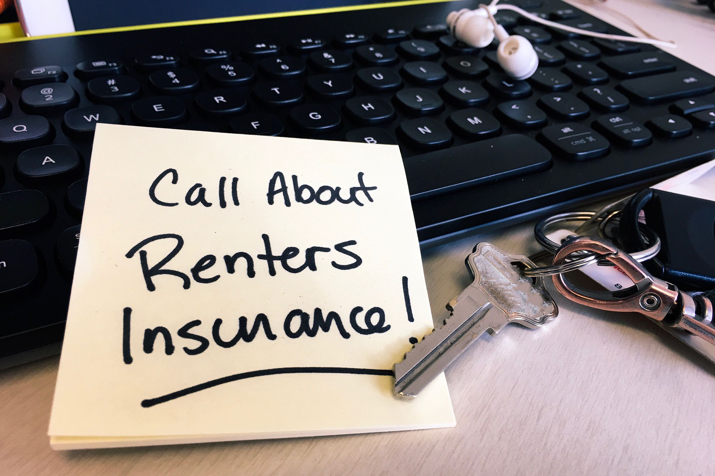 note on desk keyboard to call about renters insurance