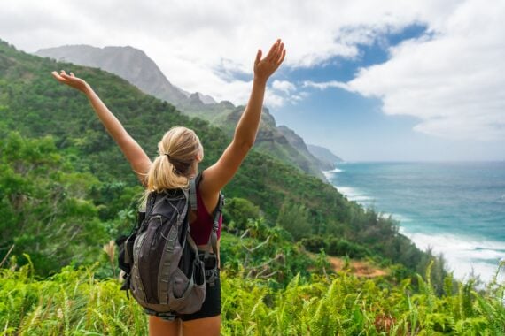 hiker with hands up in Kauai, Hawaii