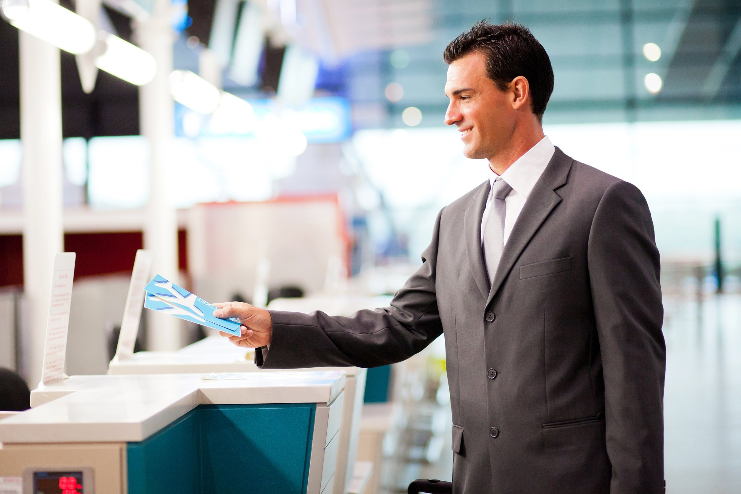businessman handing over air ticket at airline check in counter
