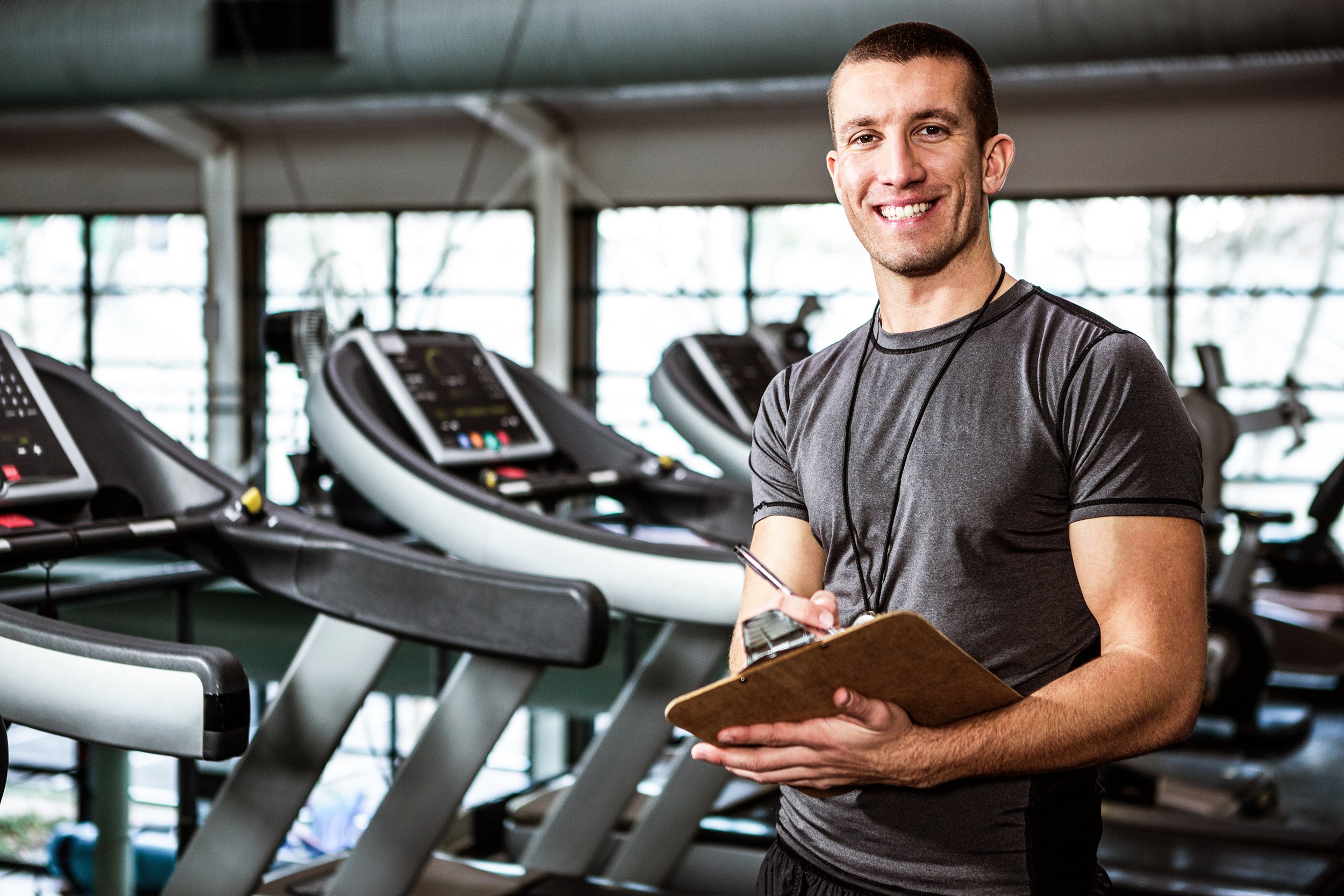 Fitness instructor with a clipboard at the gym