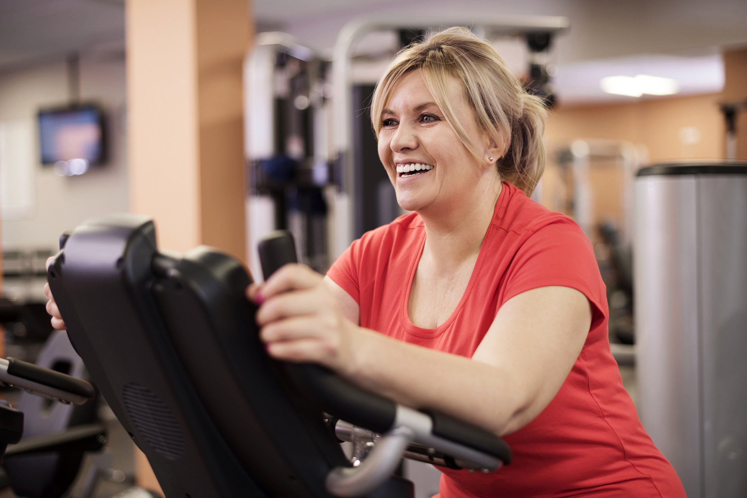 Woman on a treadmill smiling