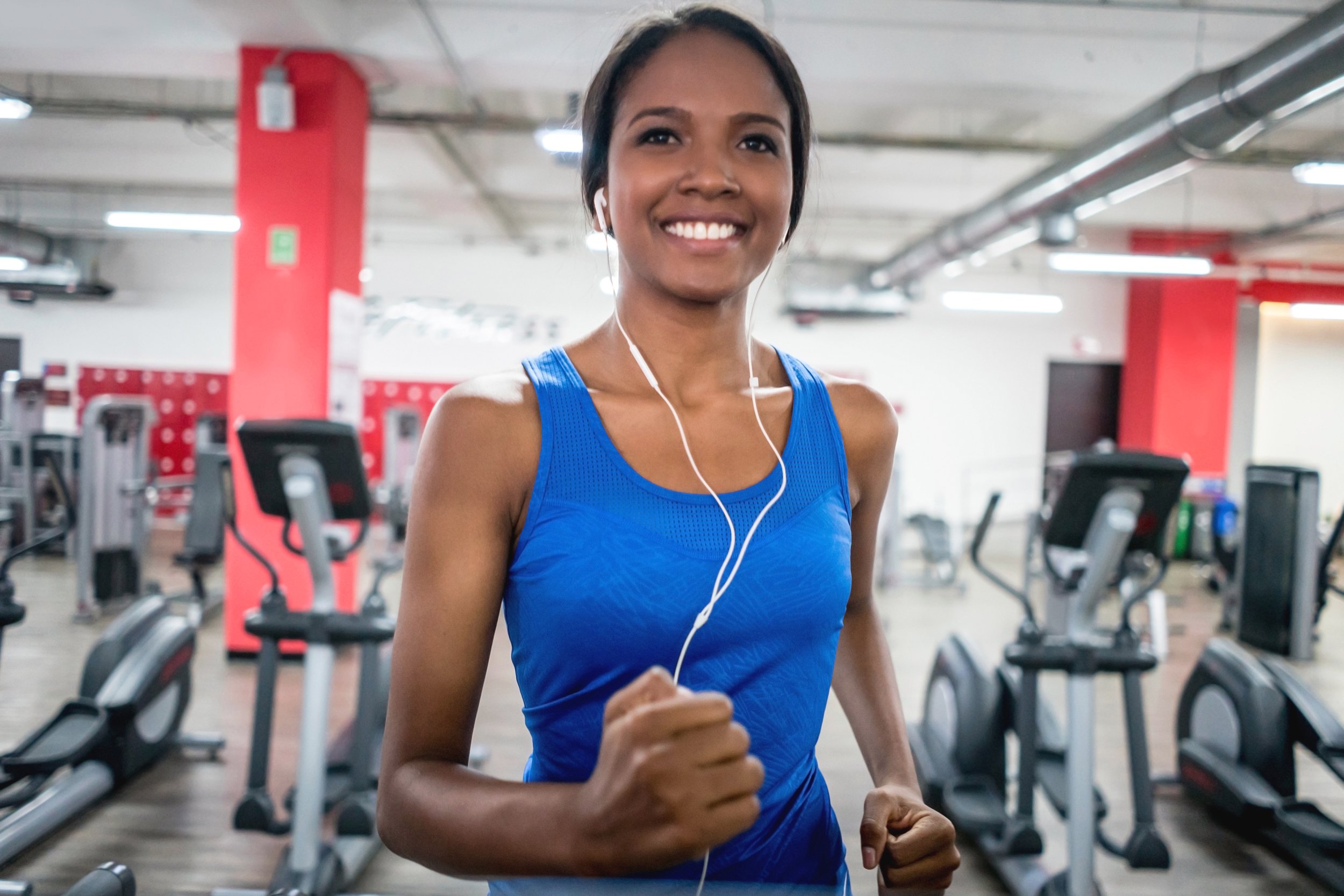 Woman listening to music on the treadmill at work