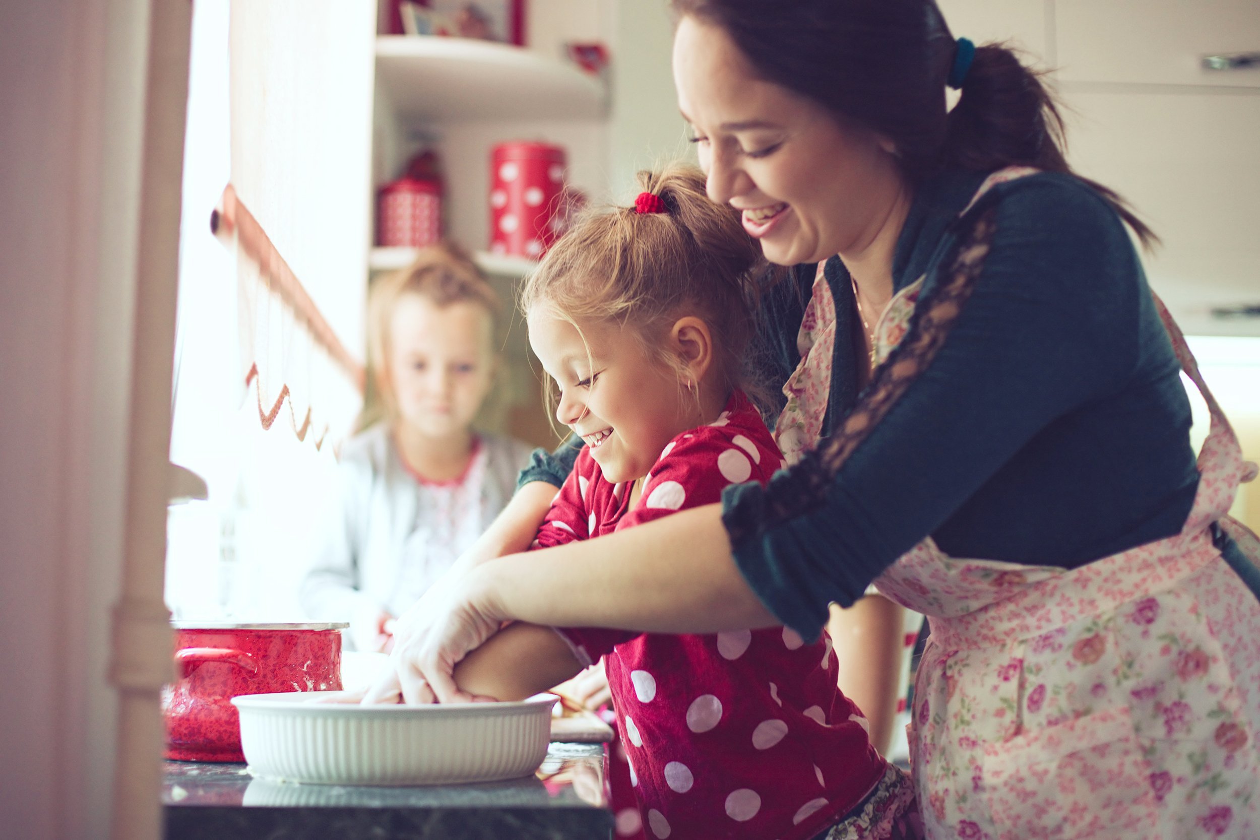 mother with her 5 years old kid cooking holiday pie in the kitchen