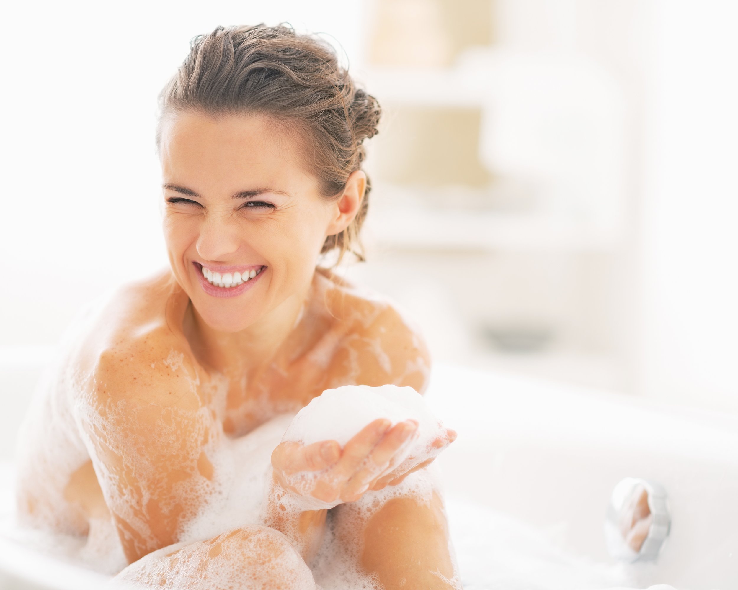 woman playing with foam in bathtub