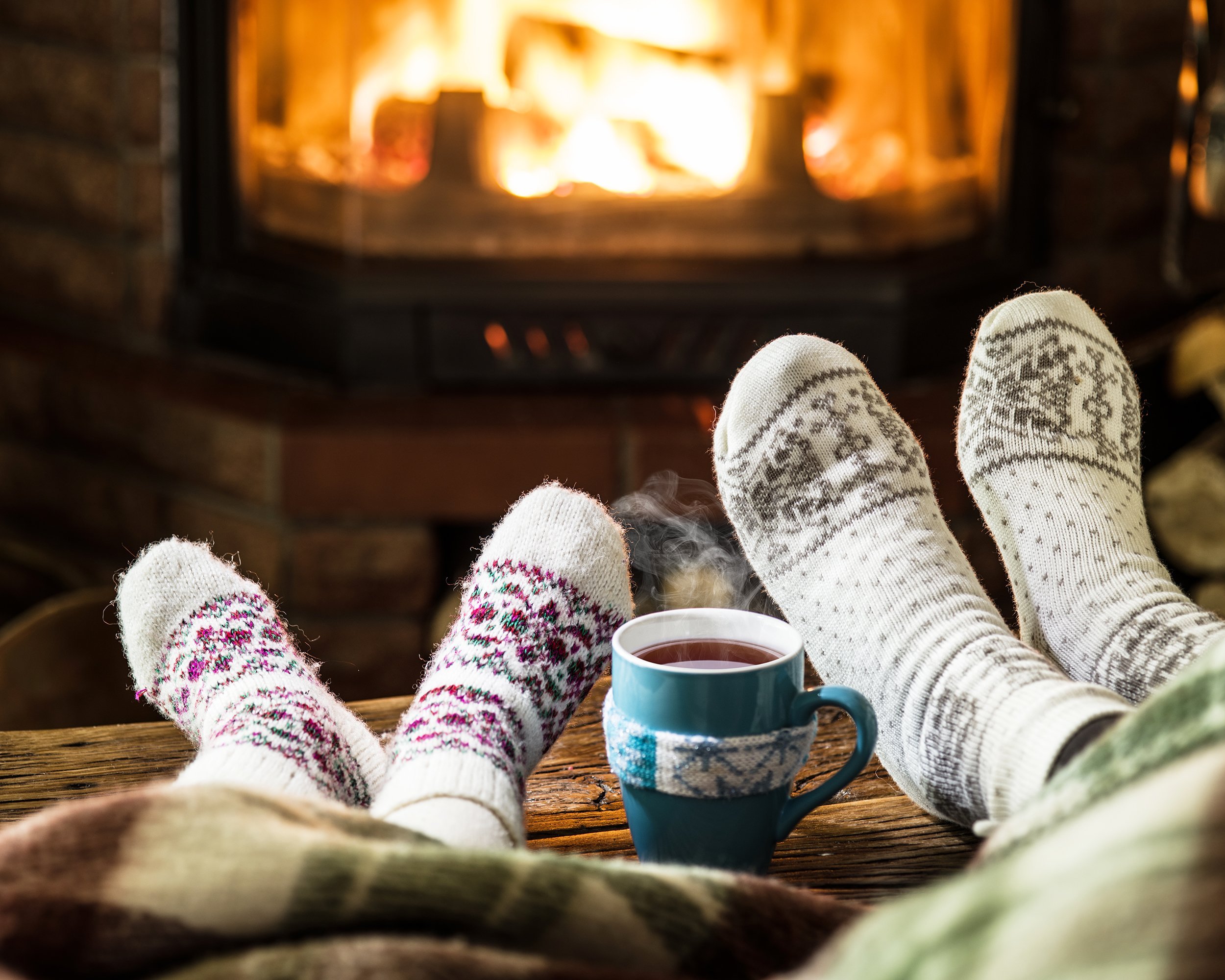 warming and relaxing feet near fireplace