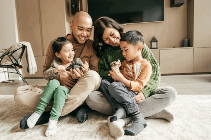 happy family sitting at home in living room