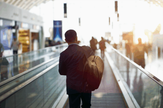 Man on airport escalator