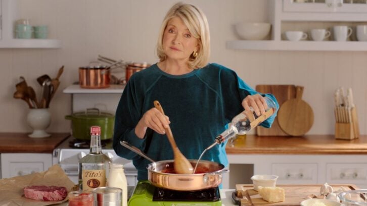Martha Stewart in a kitchen pouring Tito's vodka