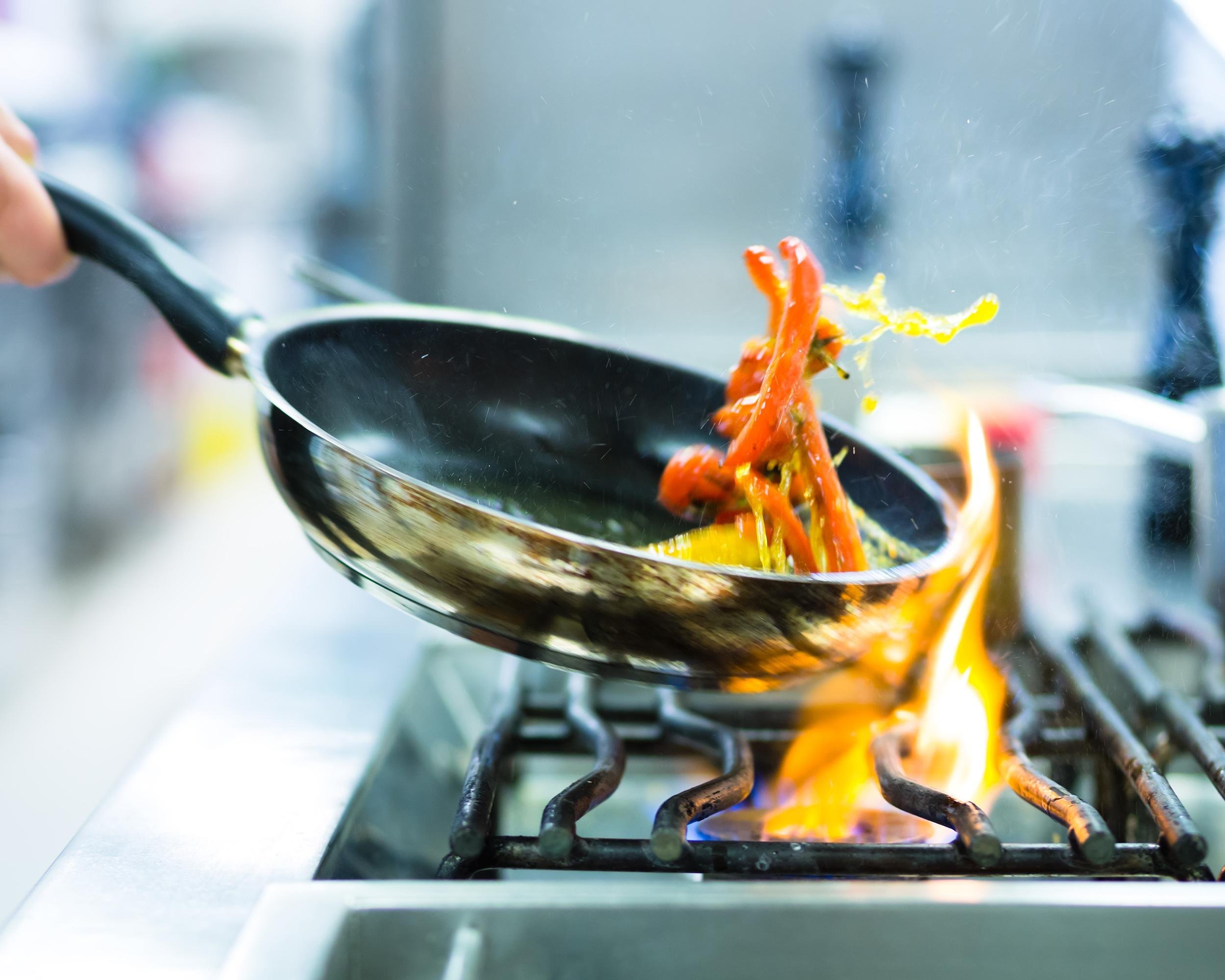 cooking in kitchen with flame