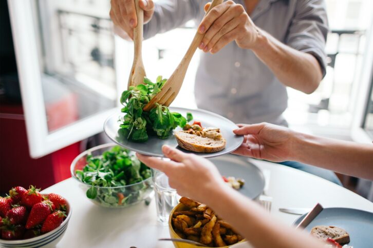 Serving salad on a plate for lunch