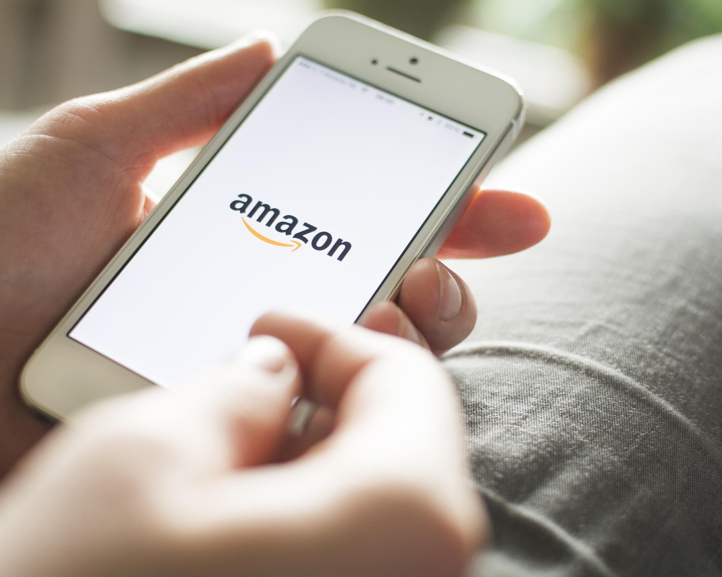 hand with mobile on Amazon