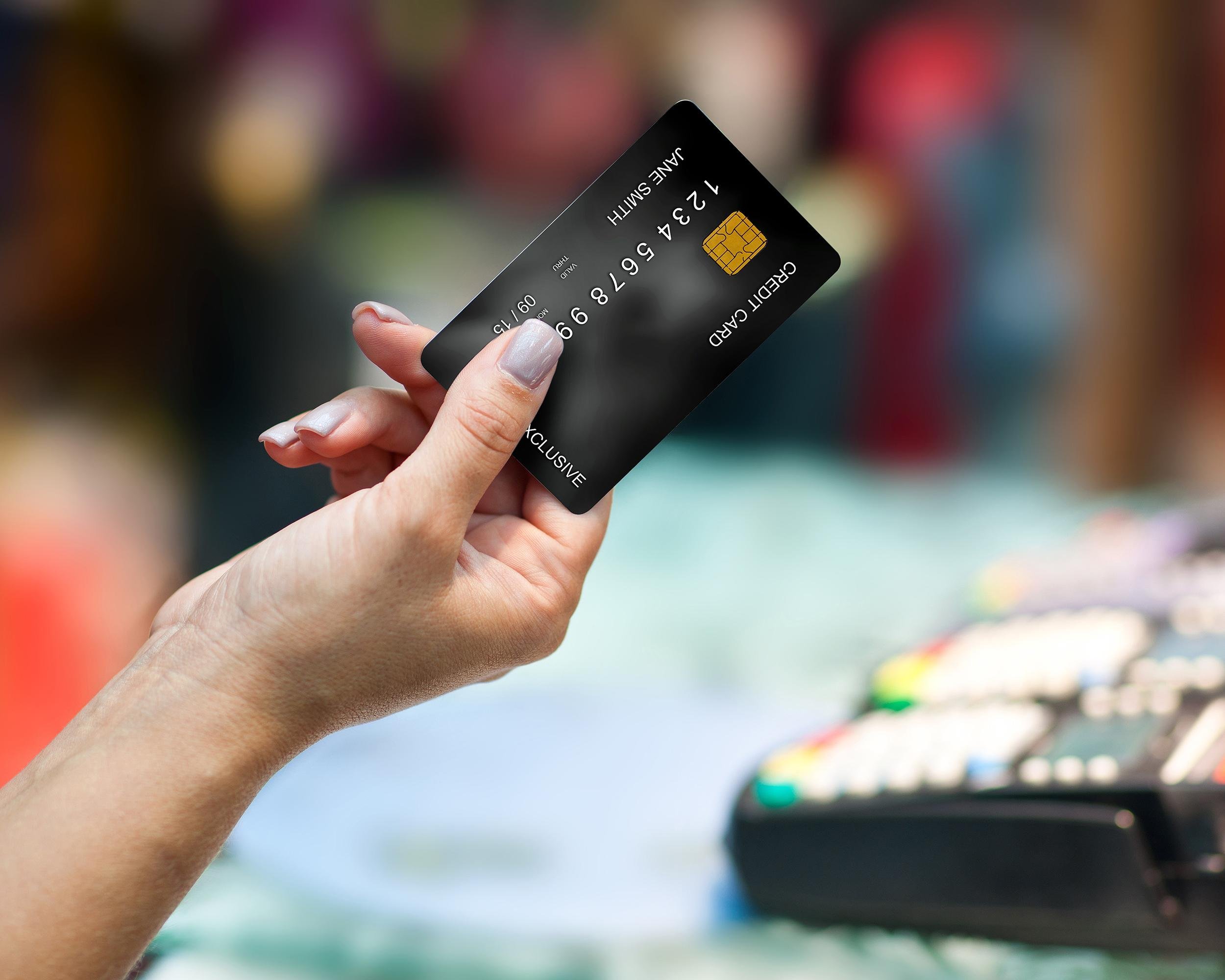 hand holding credit card in shop