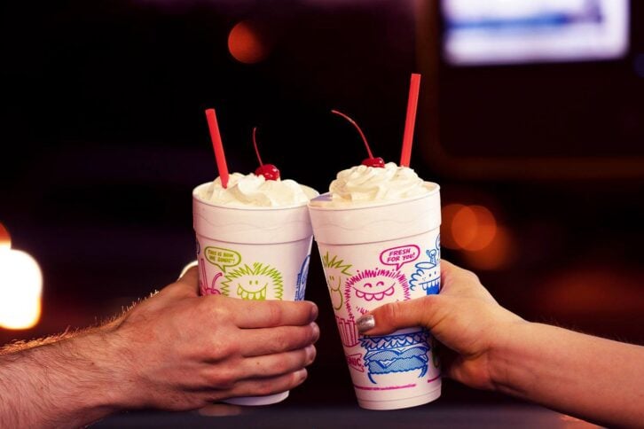 two people with sonic milkshakes in hand
