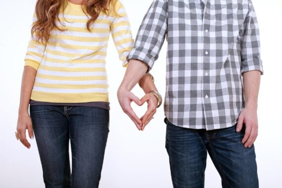 heart shaped hands of couple in love