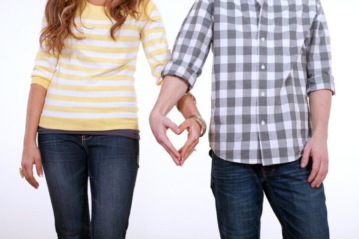heart shaped hands of couple in love