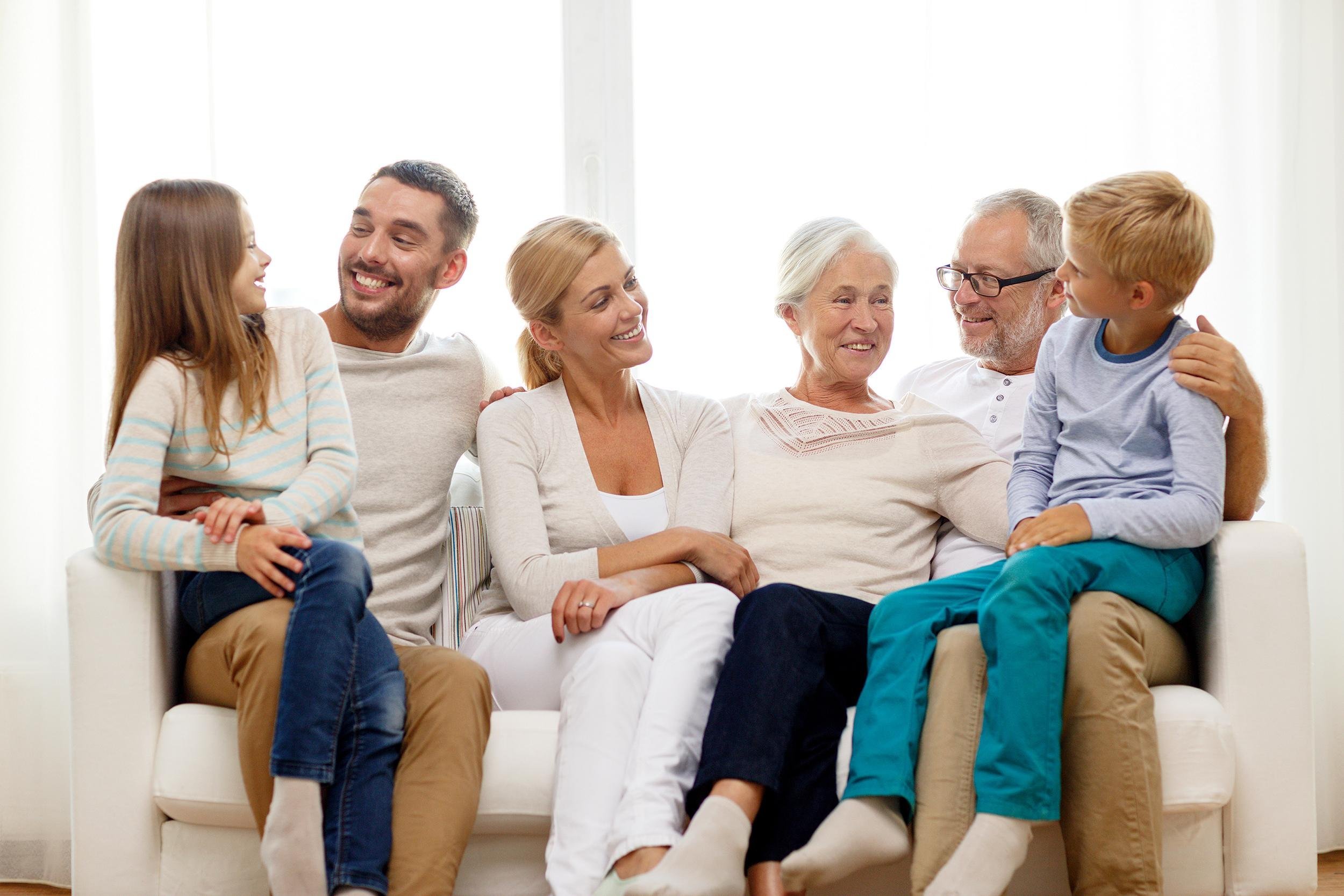happy family sitting on couch at home