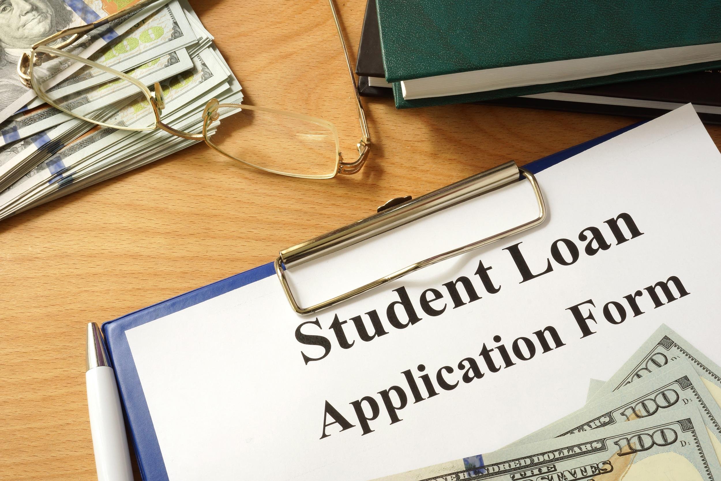 student loan form with dollars and books