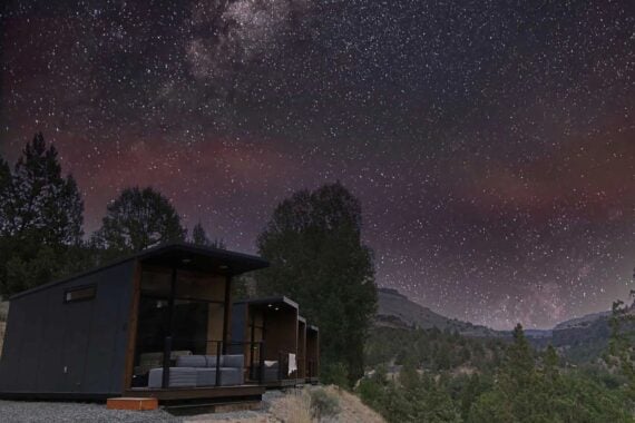 A row of Tiny Heirloom eXpanses on the bottom left in the mountains at night, a huge starry sky
