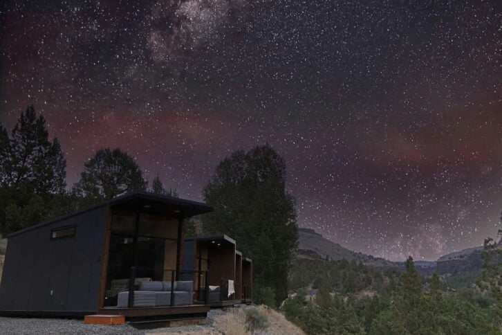 A row of Tiny Heirloom eXpanses on the bottom left in the mountains at night, a huge starry sky