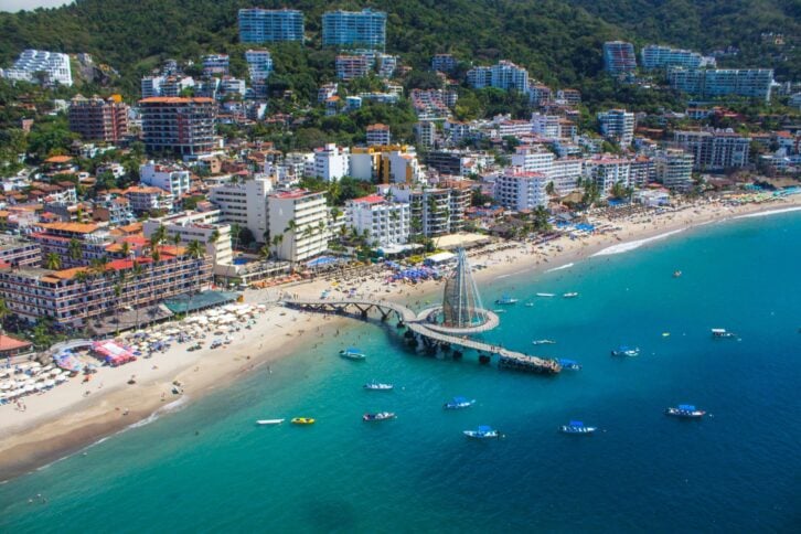 Aerial view of pier and beach of Puerto Vallarta, Mexico bay on a sunny day