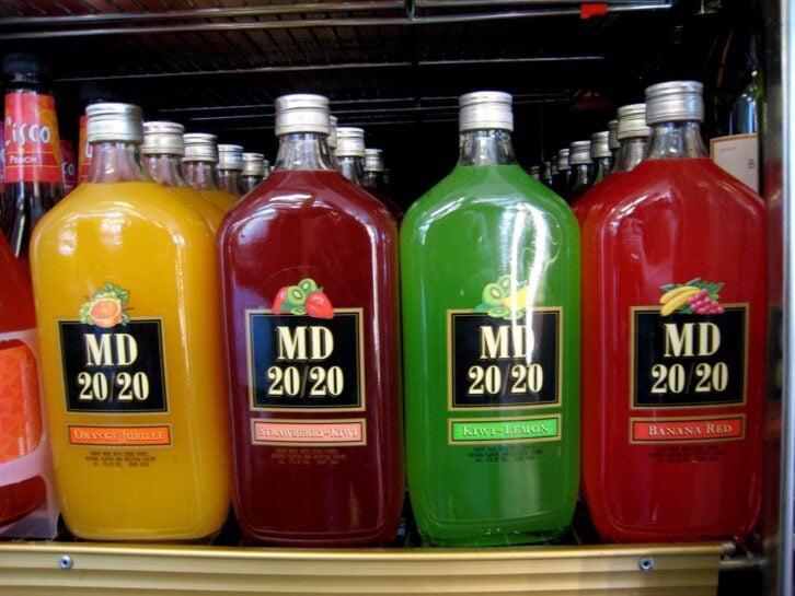 Rows of Orange Jubilee, Strawberry-Kiwi, Kiwi-Lemon, and Banana Red bottles of MD 20/20 wine.