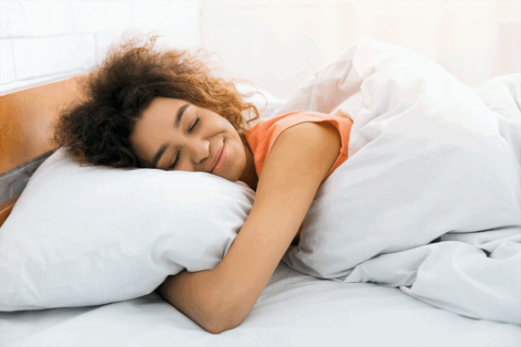 woman sleeping happily on pillow