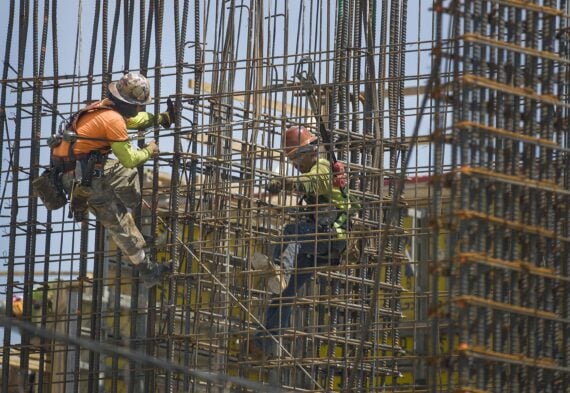 Construction workers are seen as they work with steel rebar during the construction of a building on May 17, 2019 in Miami, Florida.