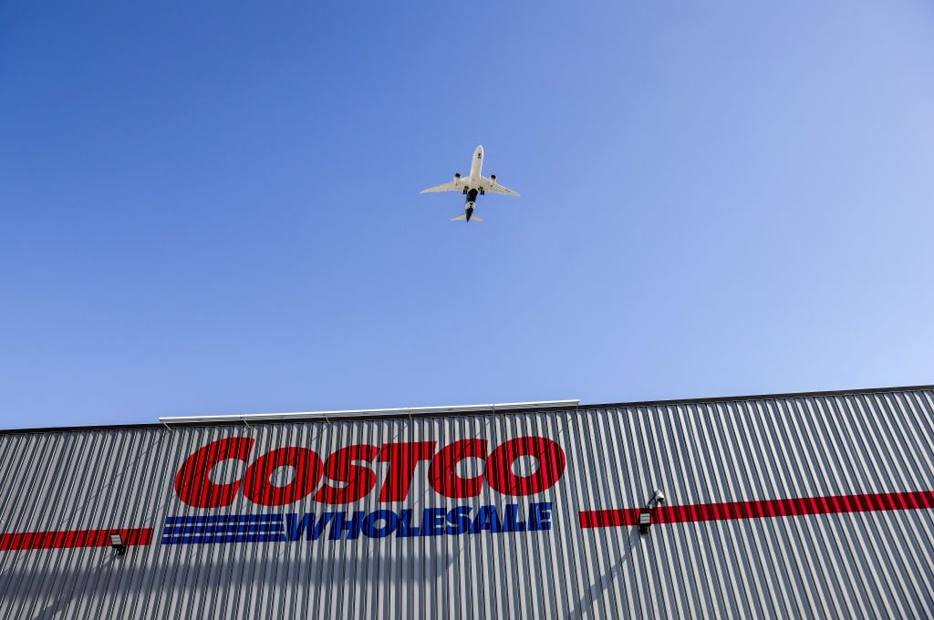 The Costco logo is displayed at a Costco store as a plane descends to land on February 25, 2021 in Inglewood, California.