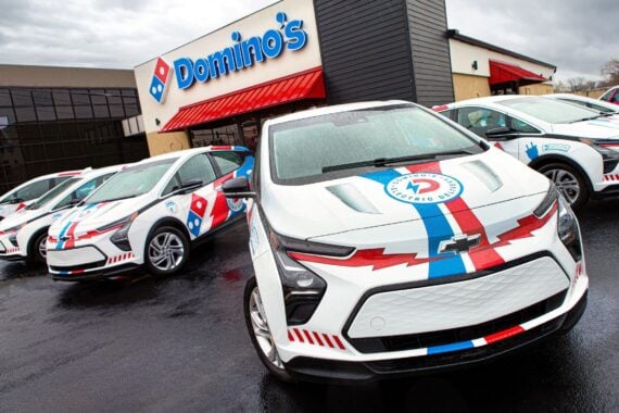 A Chevrolet Bolt electrical vehicle decorated with Domino's logos