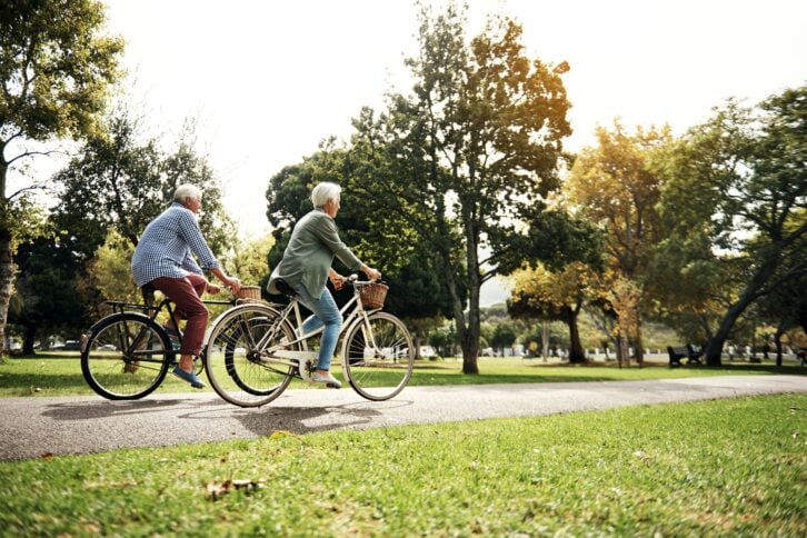 Senior couple biking outside