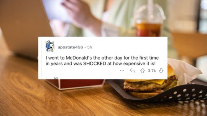Businesswoman working at laptop with fast food on restaurant table