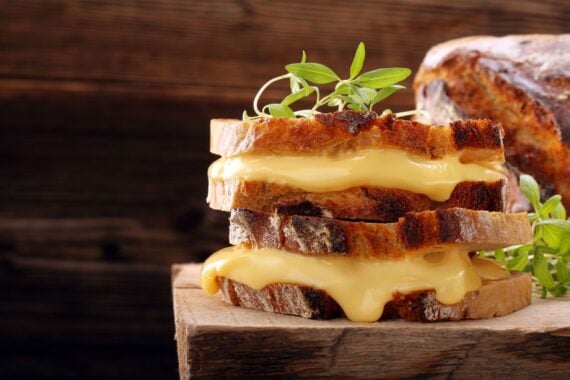 Grilled cheese sandwich on rustic bread with fresh herbs
