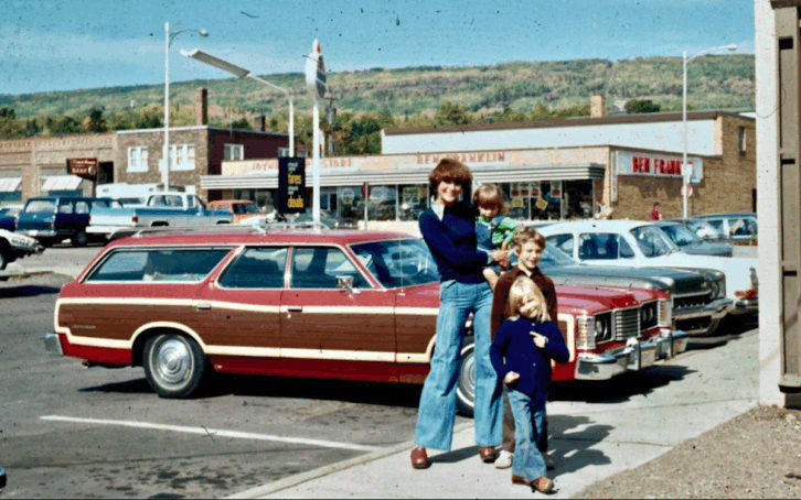 A mom and her kids in front of their station wagon in Grand Marais, Minnesota, 1975. Ford LTD Country Squire