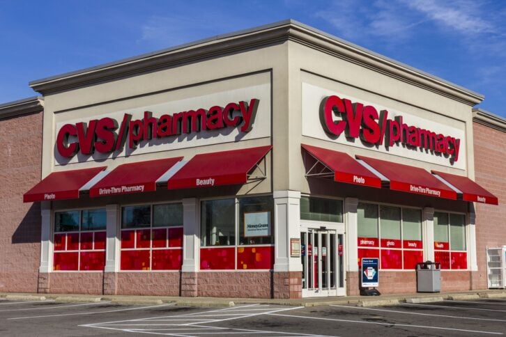 Front exterior of CVS Pharmacy, Anderson, California, surrounded by empty parking spaces, against a blue sky