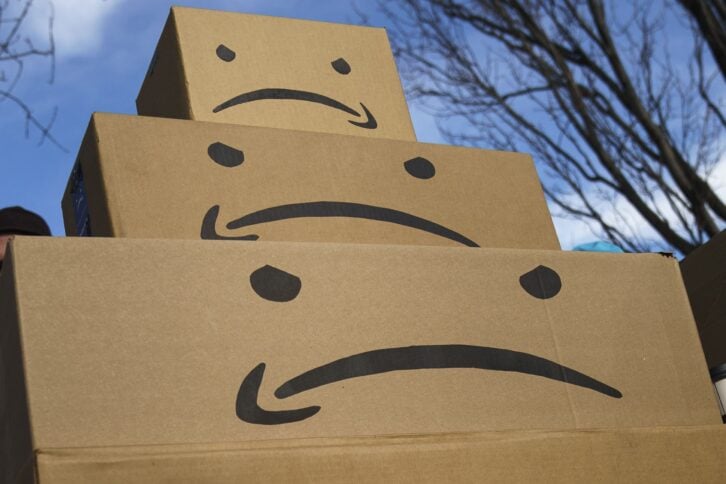 boxes with the Amazon logo turned into a frown face are stacked up