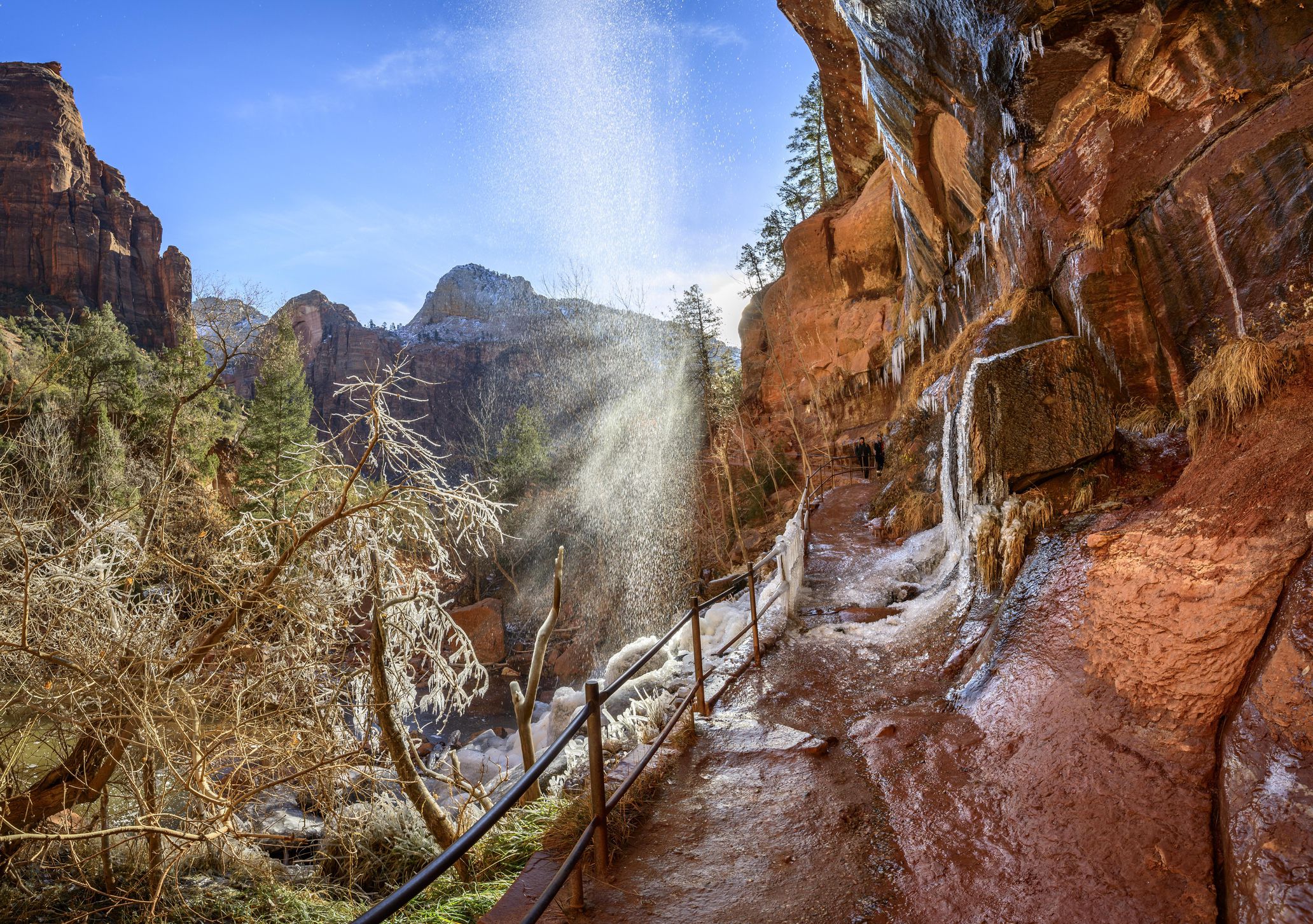 Waterfall falls from overhanging rock in winter, Emerald Pools Trail hiking trail along Virgin River, Zion National Park, Utah, USA
