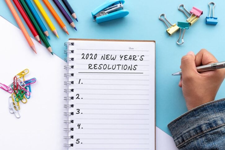 notebook with 2020 new year's resolutions written on it