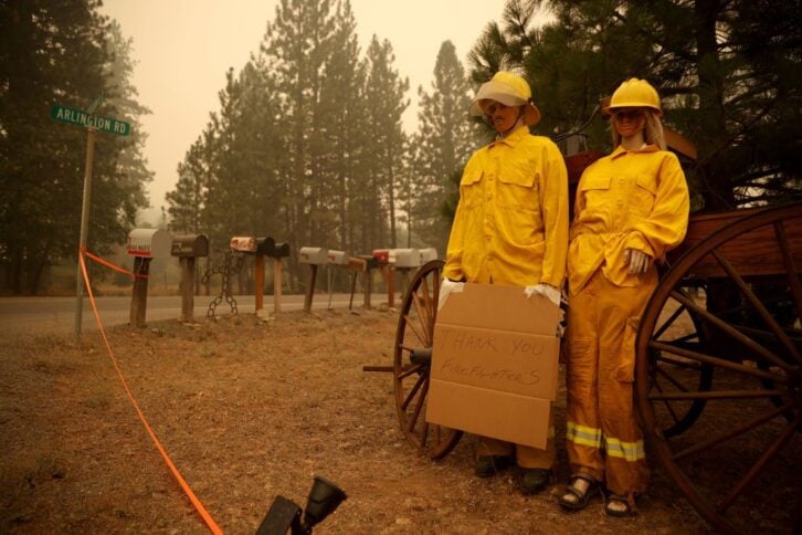Mannequins dressed in firefighter gear hold a sign thanking firefighters for the work they have done on the Dixie Fire on August 11, 2021 in Taylorsville, California.