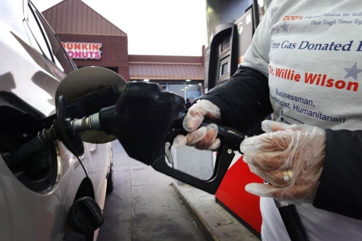 A worker pumps free gas for a motorist at a gas station in the Humboldt Park neighborhood on March 17, 2022 in Chicago, Illinois. Businessman and philanthropist Willie Wilson gave away $200,000 worth of gas which was distributed to residents at 10 gas sta