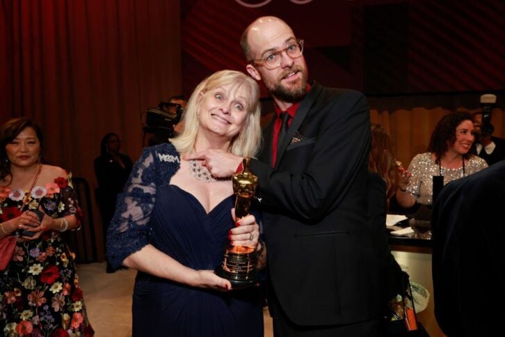 Man with Oscar next to woman
