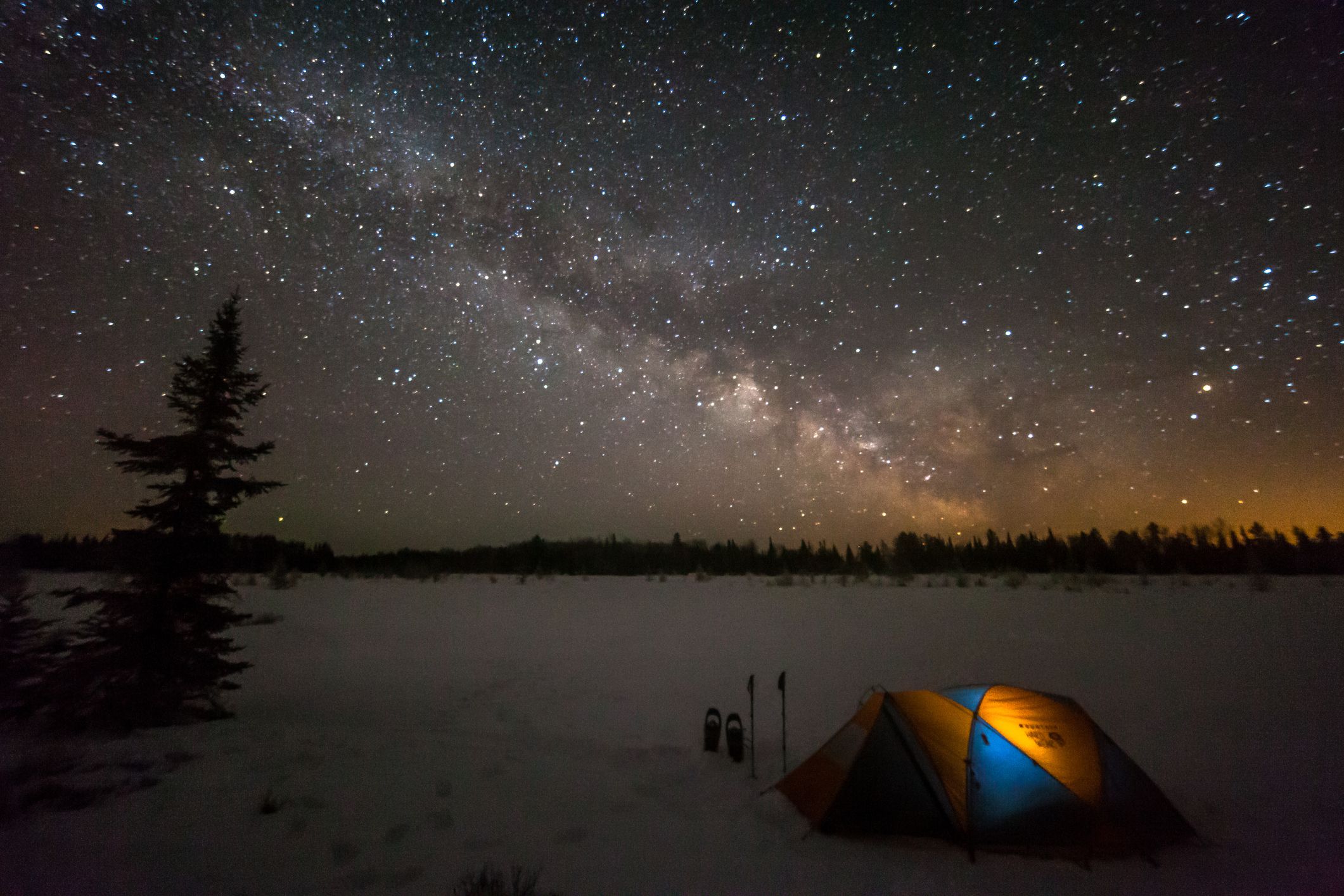 Camping tent under the stars in snow