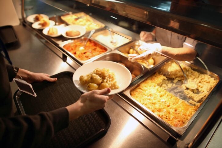 a student takes a plate during lunch time at a secondary school on december 1, 2014 in london, england