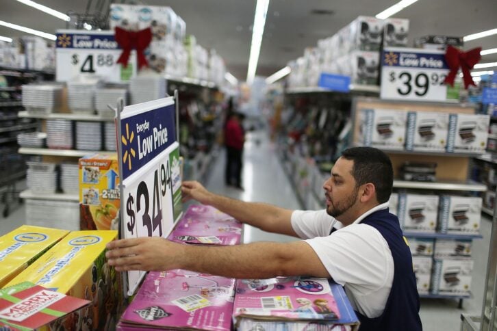 Jaime Vado fixes a display in the isle at a Walmart store as they prepare for Black Friday shoppers on November 24, 2015 in Miami, Florida.