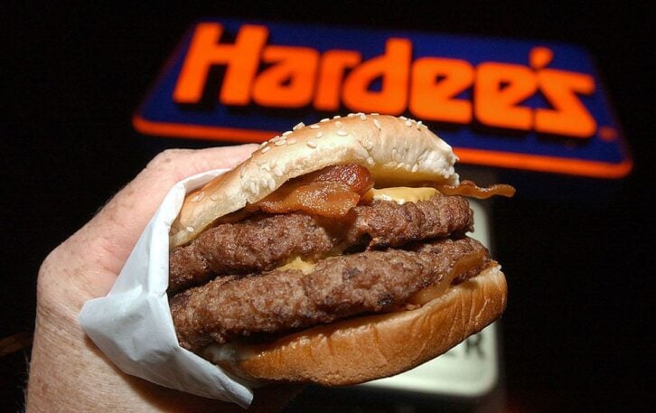 A Hardee's Monster Thickburger at a restaurant in Columbus, Georgia on November 17, 2004. The newly introduced hamburger is 2/3 of a pound of Angus beef and features four strips of crispy bacon, three slices of American cheese, and some mayonnaise on a bu