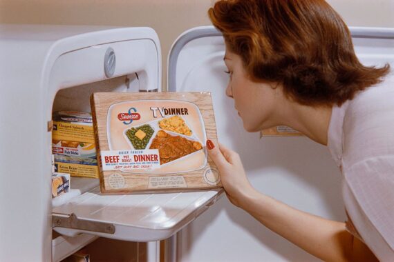 Color vintage photo of Woman Choosing TV Dinner from Freezer in the 1950s
